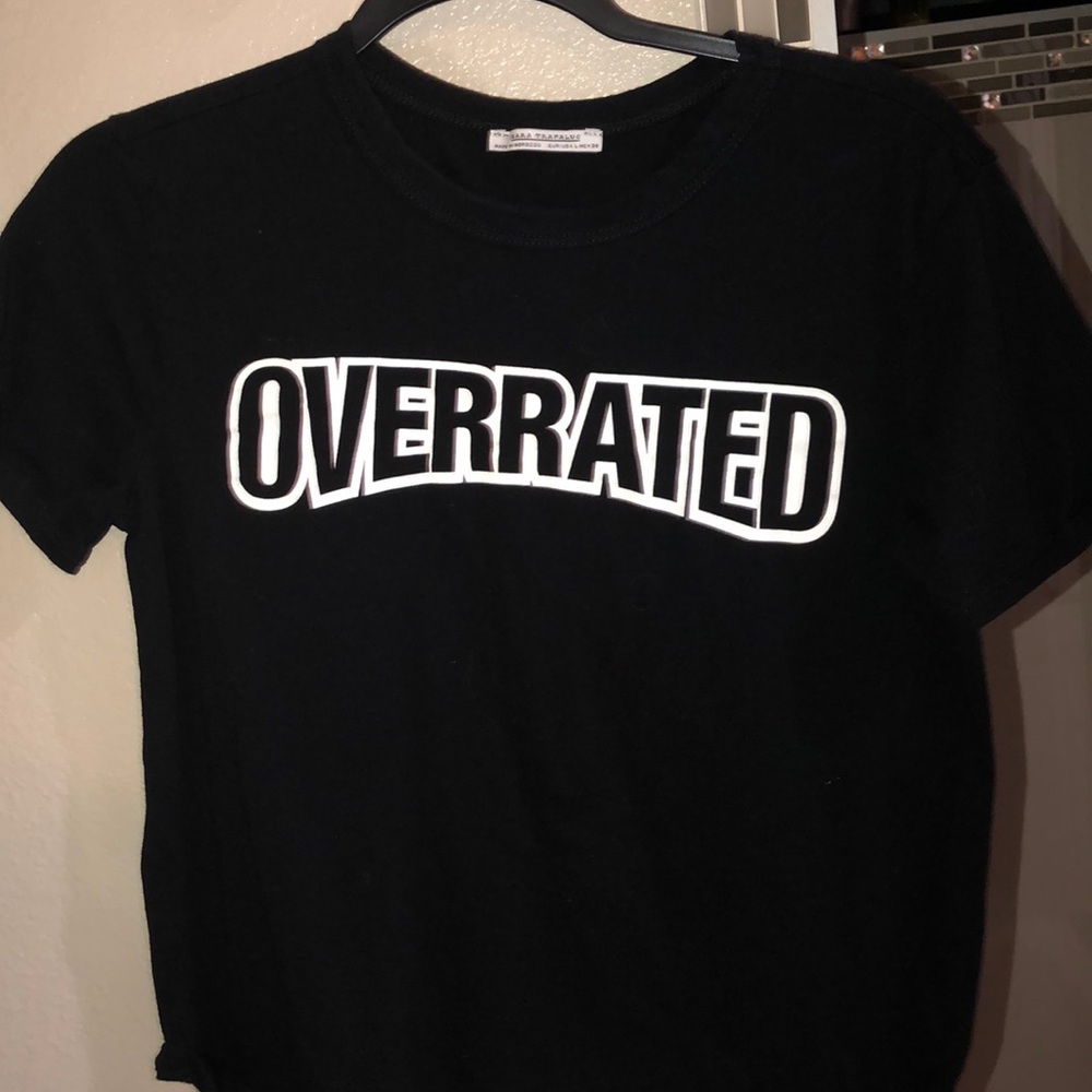 black t-shirt that says “overrated”